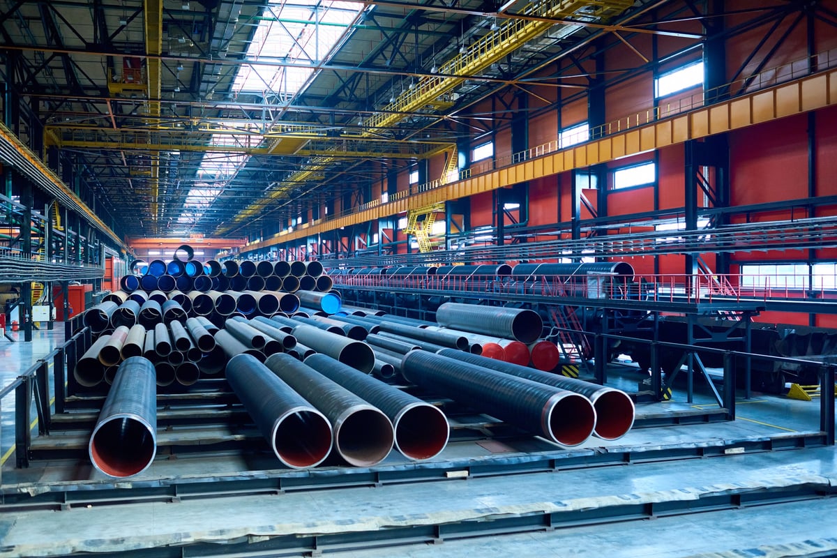 Abundance of tubes used for the oil and gas industry placed in a factory warehouse